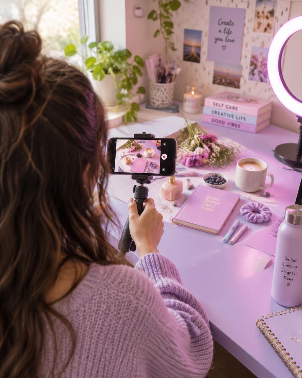A faceless content creator filming a Reel behind the camera with a phone on a tripod